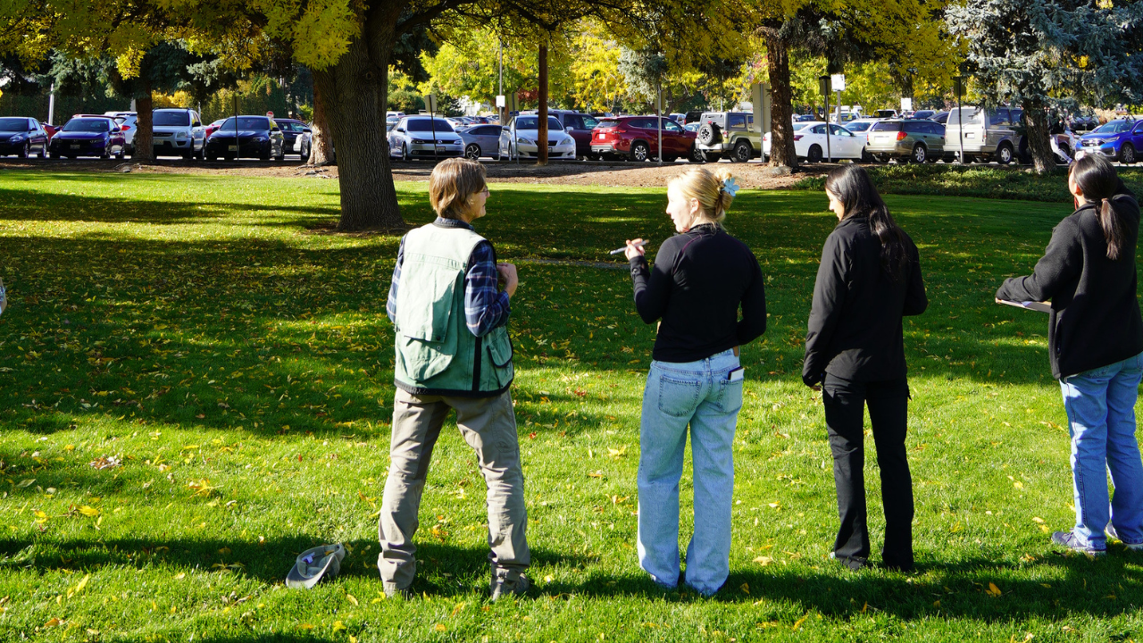 Students and community member taking tree measurements on Arbor Day 2025