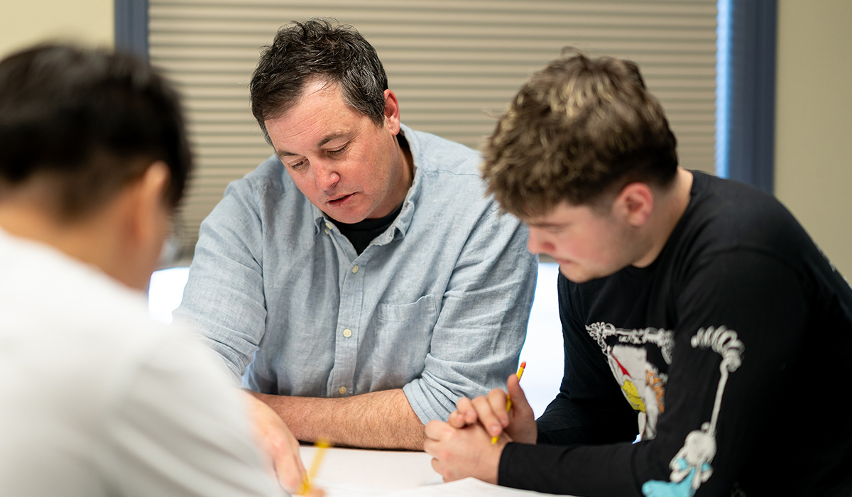 A WVC Omak faculty member helps a student with an assignment.