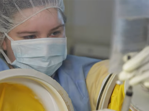 A screenshot from the WVC Allied Health video of a pharmacy technician student holding a syringe.