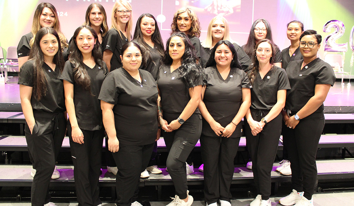 The 2025 WVC Medical Assistant graduates stand in a group on a stage.