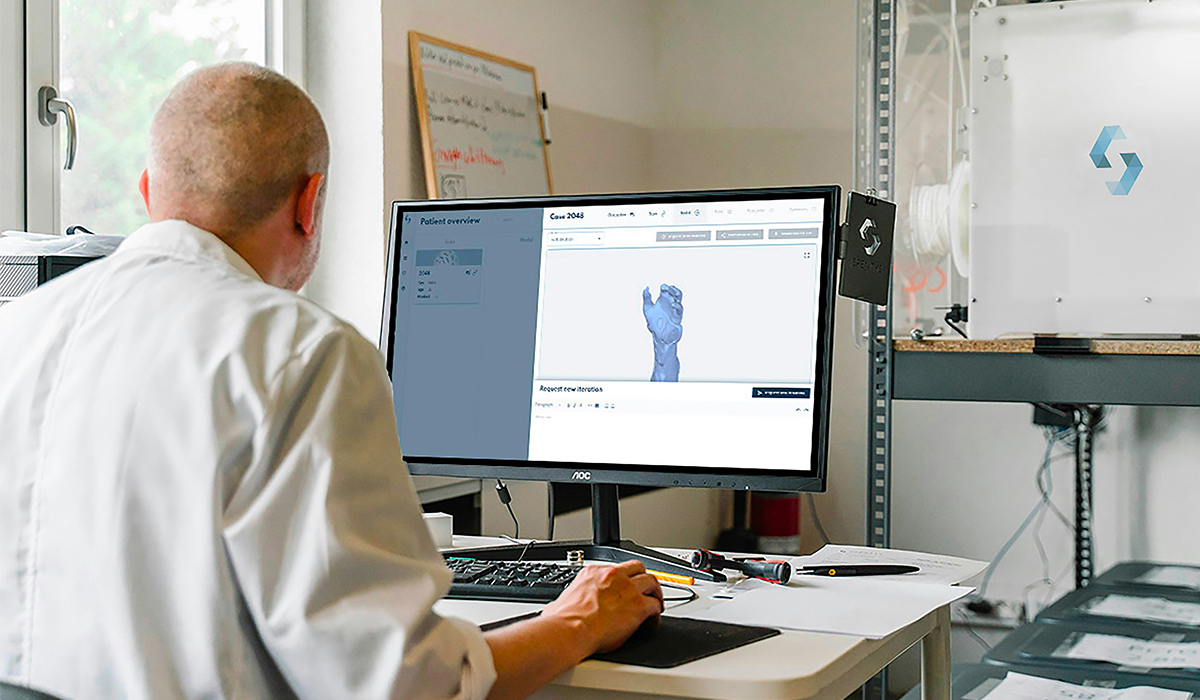 A digital designer works at a computer.