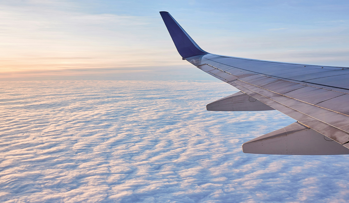 A view through an airplane window of the airplane's wing