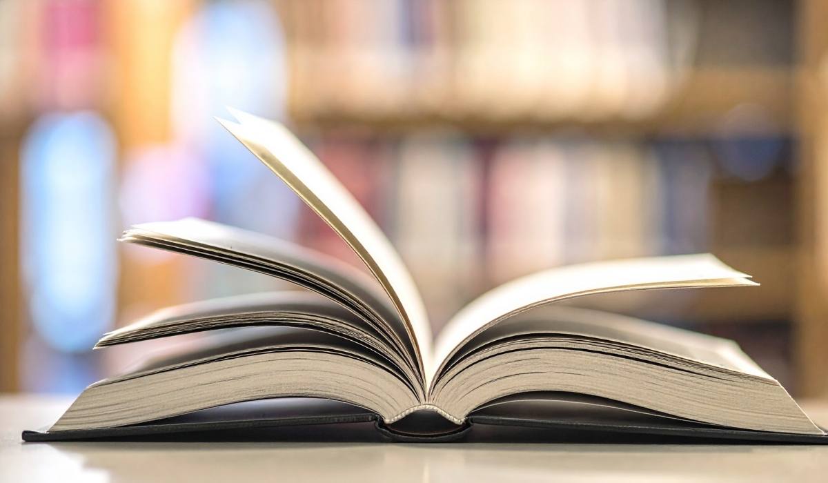 A single book open on a table in a bookstore environment